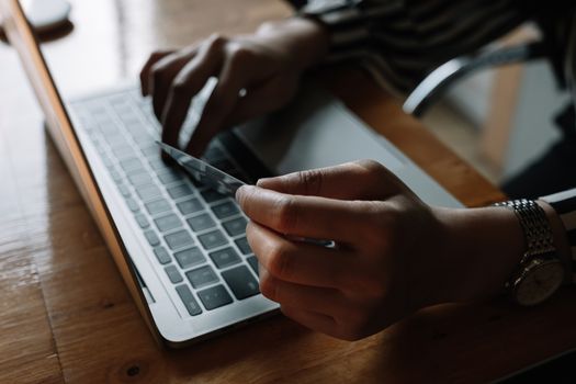 close up woman using laptop and credit card for pay online shopping e-commerce online payment concept