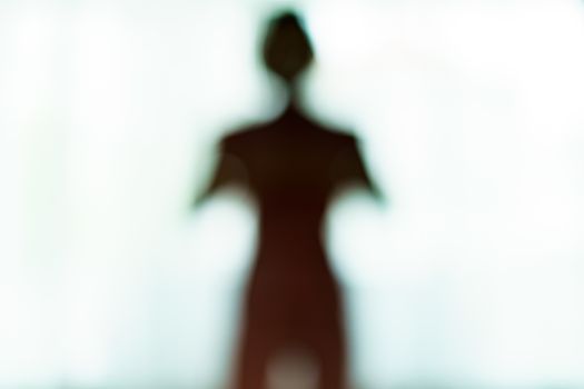 Blurred silhouette of human body look like alien.