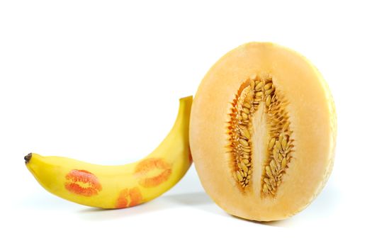 Melon and banana with red lipstick marks on white background, Sex concept. isolated