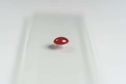 Human blood on slide glass microscope in laboratory.