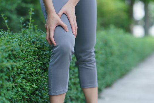 Women with knee pain. Sport exercising injury. Woman in pain while running.
