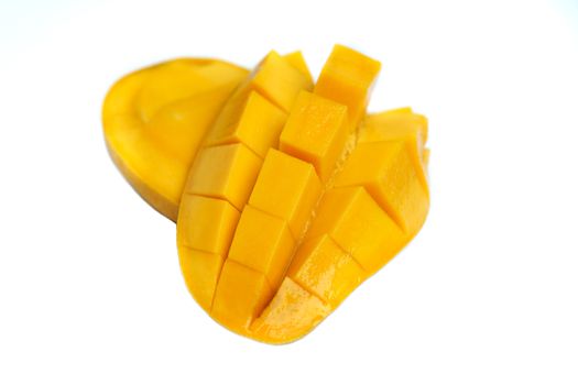 Yellow mango and mango slice on cubes isolated white isolated background.