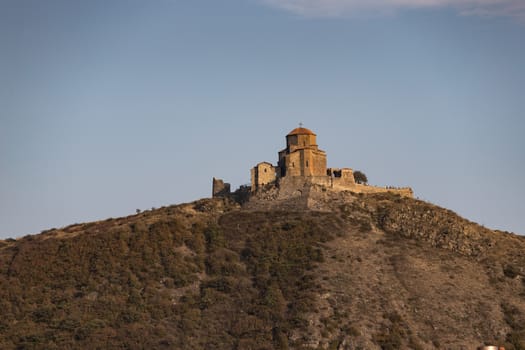 Jvari Monastery is a sixth-century Georgian Orthodox monastery near Mtskheta, eastern Georgia. Late afternoon sun highlighting textures of warm brown stones