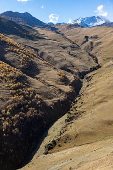 Kazbegi region of Georgia, snow capped mountains and rugged terrain. Mount Kazbegi is a dormant strato-volcano and one of the major mountains of the Caucasus located on the border of Georgia's Kazbegi District and Russian Republic of North Ossetia Alania. High quality photo