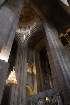 The Svetitskhoveli Cathedral, Mtskheta Georgia 05/10/2019 beautiful interior image looking up to the central dome with murals and icons.