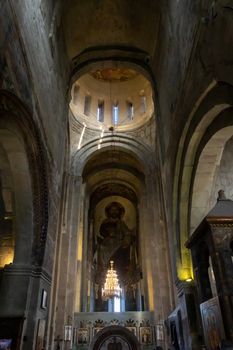 The Svetitskhoveli Cathedral, Mtskheta Georgia 05/10/2019 beautiful interior image looking up to the central dome with murals and icons.