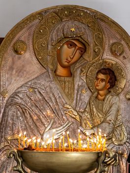 The Monastery of St. Nino at Bodbe is a Georgian Orthodox monastic complex and the seat of the Bishops of Bodbe located 2 km from the town of Sighnaghi, Kakheti, Georgia Interior icon of Jesus and Mary with candles, glowing gold