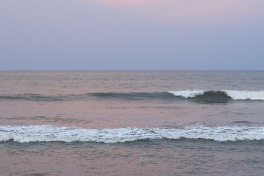 Sunset on the beach with sweet waves