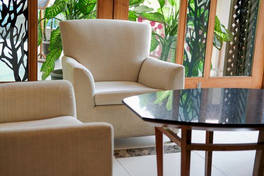 beige cushion sofa chair armchair in living room. home interior
