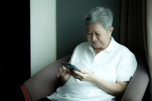 asian elder senior woman using mobile smart phone. elderly female holding cellphone. mature retirement lifestyle