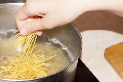 cooking spaghetti in a saucepan close-up