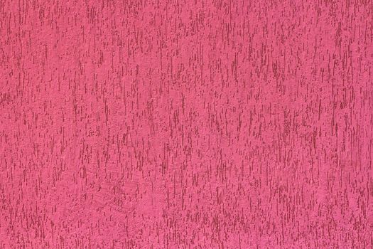 Front view of a pink wall with irregular texture.
