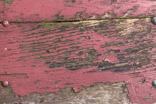 Front view of a wooden board with peeling paint.