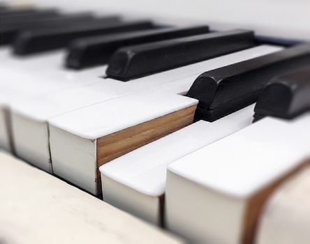 Close-up view of the keys of a vintage piano. Shallow DOF.