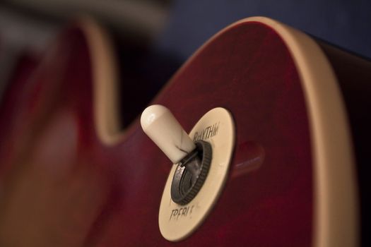 Extreme close up of a pickup selector switch to electric guitar.
