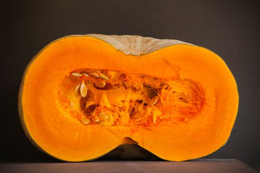 A freshly cut white pumpkin on a wooden tray.