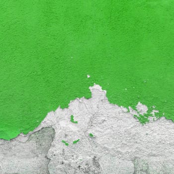 Fragment of wall with broken stucco. Old green wall with damaged shabby color plaster. Distressed wall background. Concept of renewal, of restore and repair.