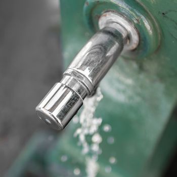 Water fountain in a public garden. Extreme closeup. Top view.