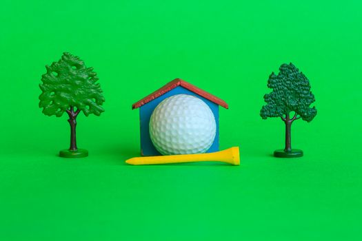a house with a golf ball surrounded by trees and greenery , is the symbol of the presence of a golf -club