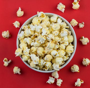 close up of mushroom Popcorn in a white bowl with red background.Top view.