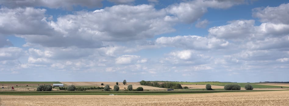 summer landscape and blue sky in the north of france near amiens