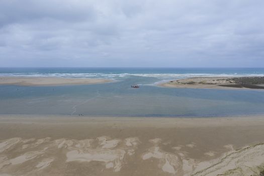 Aerial view of a sand dredger boat at the mouth of the Murray River in South Australia