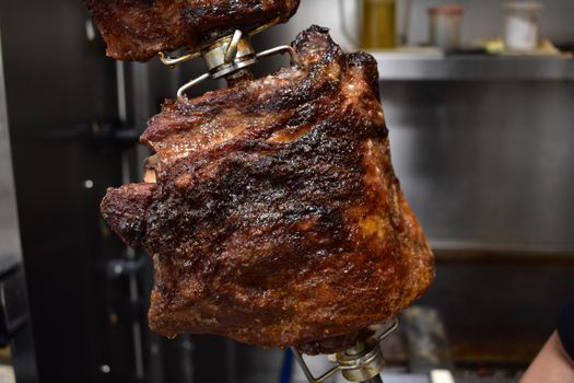 A Close Up of a Well-Done Rack of Ribs inside a Rotisserie