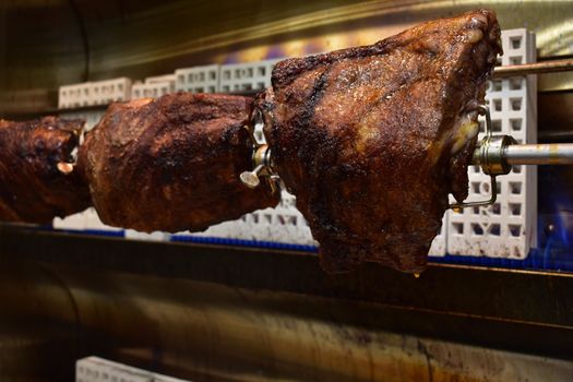 Three Well-Done Racks of Ribs Inside a Rotisserie