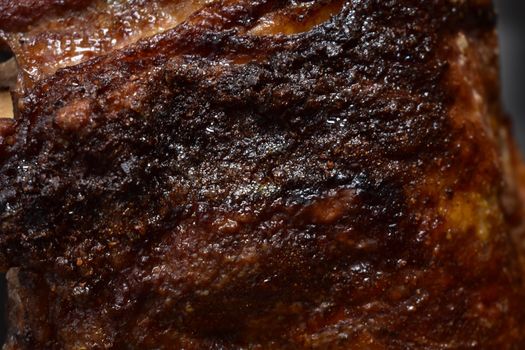 A Close Up of a Well-Done Rack of Ribs inside a Rotisserie