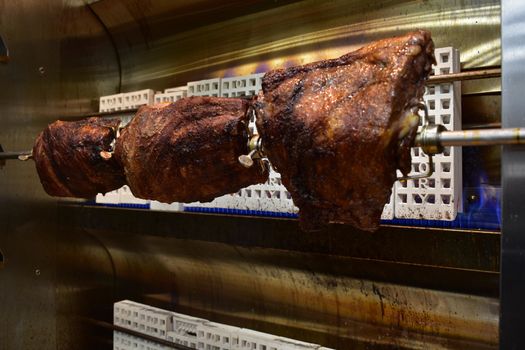 Three Well-Done Racks of Ribs Inside a Rotisserie