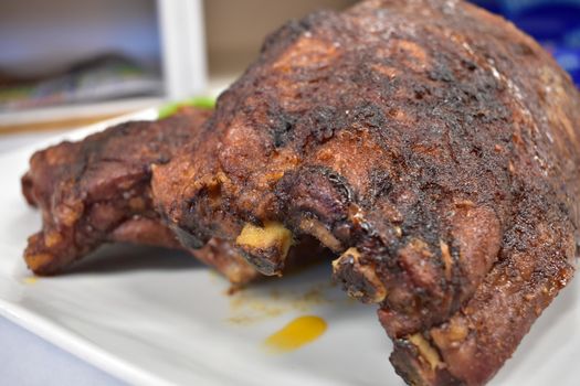 A Well-Done Rack of Ribs Plated on a White Background