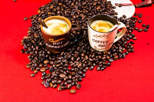 Cup of coffee, roasted coffee beans on red background, top view, copy space for text, coffee concept, close up coffee photo