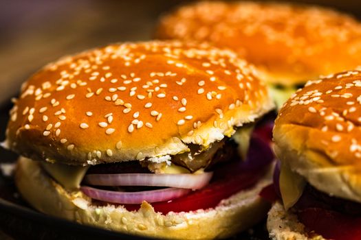 Closeup of fresh homemade tasty burgers on wooden table