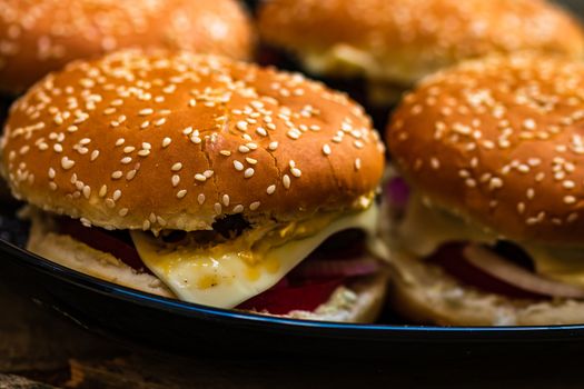 Closeup of fresh homemade tasty burgers on wooden table