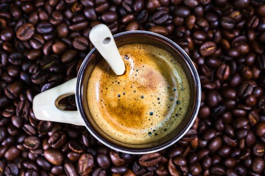 Coffee cup with roasted coffee beans on red background, coffee concept, close up coffee photo