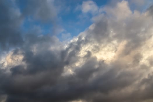 Beautiful panorama of orange and yellow clouds at sunrise and sunset in a blue sky