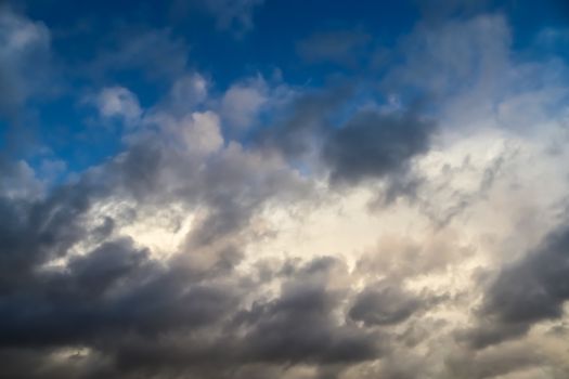 Beautiful panorama of orange and yellow clouds at sunrise and sunset in a blue sky