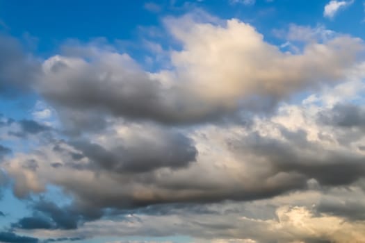 Beautiful panorama of orange and yellow clouds at sunrise and sunset in a blue sky