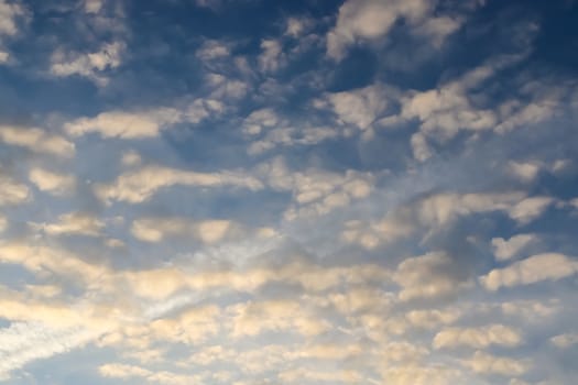 Beautiful panorama of orange and yellow clouds at sunrise and sunset in a blue sky