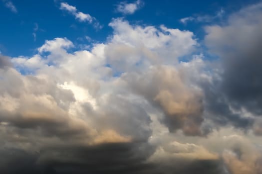 Beautiful panorama of orange and yellow clouds at sunrise and sunset in a blue sky