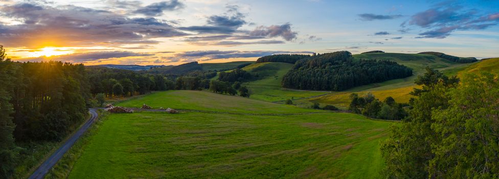 Panorama Of A Beautiful Sunset Over Gentle Rolling Hills In The Scottish Borders