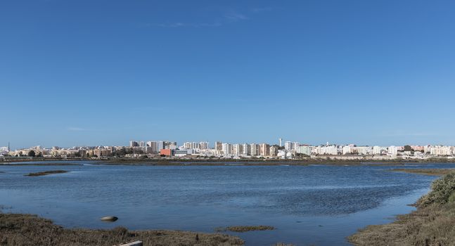 Faro, Portugal - February 26, 2020: City view from the commercial harbor by the sea on a winter day