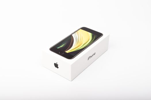 Paris, France - May 14, 2020: packaging of the new black iPhone SE 2020 from the multinational company Apple during the days of its studio release on a white background