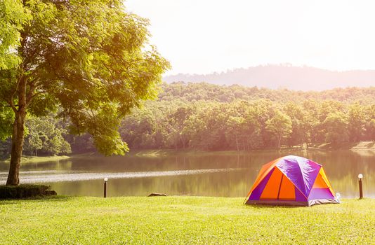 Tourist dome tent camping at lake side  in forest camping site