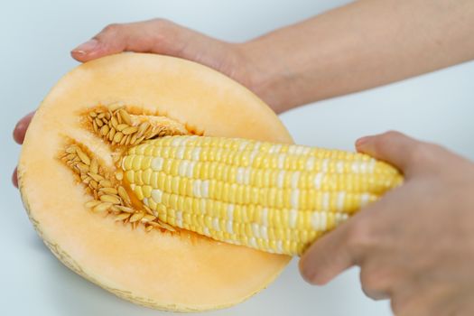 Melon and sweet corn on white background, Sex concept.