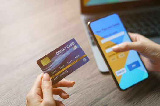 Online shopping concept : woman hands holding cradit card and using credit card online shopping.