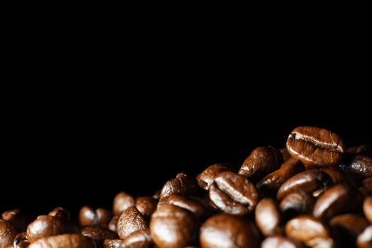 Roasted Coffee Beans texture on dark background, macro.