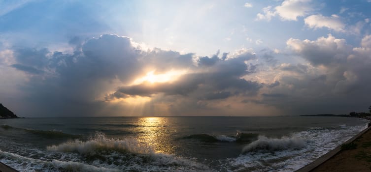 Panoramic sunset with fluffy clouds in the twilight sky,Sunlight with dramatic cloud over sea