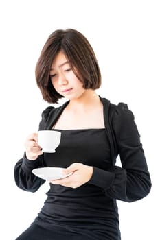 Young woman sittng holding coffee cup on white background