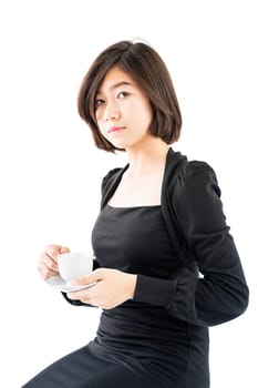 Young woman sittng holding coffee cup on white background